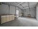 A simple garage with storage cabinet, work area, and open space on a concrete floor at 221 Se 167Th Ct, Silver Springs, FL 34488