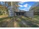 Large detached metal garage with open doors and surrounding trees at 221 Se 167Th Ct, Silver Springs, FL 34488