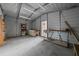 Interior angle of the garage showcasing storage, shelving, lighting, and concrete floor at 221 Se 167Th Ct, Silver Springs, FL 34488