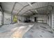 Spacious garage with concrete floor, ample lighting, and a metal roof, great for storage and projects at 221 Se 167Th Ct, Silver Springs, FL 34488