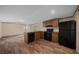 Functional kitchen featuring black appliances, wooden cabinets and laminate flooring at 221 Se 167Th Ct, Silver Springs, FL 34488