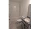 Clean bathroom with a tub and shower combination, gray vanity, and tiled floor at 261 Locust Pass Loop, Ocala, FL 34472