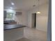 Bright and airy kitchen with stainless steel appliances, gray cabinets, and tile floors at 261 Locust Pass Loop, Ocala, FL 34472