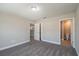 Comfortable bedroom with neutral colors, and doorways to the kitchen and bathroom at 29 Fisher Ter, Ocklawaha, FL 32179