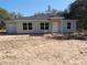 New construction home featuring gray siding, black roof, and multiple windows on a sunny day at 29 Fisher Ter, Ocklawaha, FL 32179