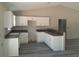 The kitchen has white cabinets, dark countertops, gray floors, and high ceilings, ready for customization at 29 Fisher Ter, Ocklawaha, FL 32179