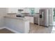 Modern kitchen with stainless steel appliances, light countertops, and a breakfast bar at 29 Fisher Ter, Ocklawaha, FL 32179