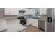 Bright kitchen features stainless steel appliances, ample counter space, and white cabinets at 29 Fisher Ter, Ocklawaha, FL 32179