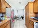 An open kitchen space that leads to a dining area with a neutral color scheme and tile floors at 3312 Sw 38Th Pl, Ocala, FL 34474