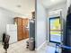 Bright, tiled kitchen features oak cabinets and neutral walls, leading to front door at 3312 Sw 38Th Pl, Ocala, FL 34474