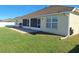 Spacious backyard with a patio, well-maintained lawn, and a home exterior with a screened in porch at 3819 Se 99Th St, Belleview, FL 34420
