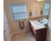 Bathroom featuring a vanity with granite countertop, dark cabinets, and chrome hardware at 3819 Se 99Th St, Belleview, FL 34420