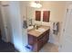 Bathroom featuring a vanity with granite countertop, dark cabinets, and chrome hardware at 3819 Se 99Th St, Belleview, FL 34420