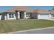 Charming single-story home with a manicured lawn, an arched entryway, and symmetrical window placement at 3819 Se 99Th St, Belleview, FL 34420