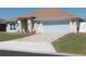 Inviting single-story home featuring an attached two-car garage, manicured lawn and a charming arched entryway at 3819 Se 99Th St, Belleview, FL 34420
