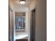 Hallway leads to a bathroom with a glass-enclosed shower and tiled floors at 3819 Se 99Th St, Belleview, FL 34420