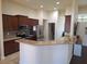 Well-lit kitchen featuring granite countertops, stainless steel appliances, and a convenient breakfast bar at 3819 Se 99Th St, Belleview, FL 34420
