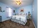 Comfortable bedroom with a floral-patterned bedspread and soft blue walls at 4941 Nw 32 Street, Ocala, FL 34482