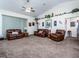 Spacious living room with plush leather furniture and vaulted ceilings at 4941 Nw 32 Street, Ocala, FL 34482