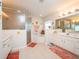 Bright main bathroom featuring a soaking tub, a walk-in shower, and dual vanities at 4941 Nw 32 Street, Ocala, FL 34482