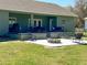 Rear patio featuring an outdoor fire pit and comfortable seating for relaxing and entertaining at 5124 Cr 634S, Bushnell, FL 33513