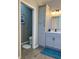 Bathroom with gray cabinets, and tiled floor, featuring a separate toilet area for added privacy at 5124 Cr 634S, Bushnell, FL 33513