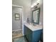 Bathroom featuring stylish vanity with quartz countertop, framed mirror, and modern lighting fixtures at 5124 Cr 634S, Bushnell, FL 33513