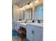 Elegant bathroom with double vanity, framed mirrors, cabinet storage, and great lighting at 5124 Cr 634S, Bushnell, FL 33513