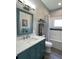 Bathroom features a teal vanity with updated countertop and a shower-tub combination at 5124 Cr 634S, Bushnell, FL 33513