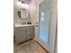 Powder room with a modern vanity, lighting, and a door to the outside at 5124 Cr 634S, Bushnell, FL 33513