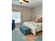 Light-filled bedroom featuring coastal decor, a ceiling fan and a storage bench at 5124 Cr 634S, Bushnell, FL 33513