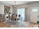 Well-lit dining room with a modern light fixture and a decorative accent rug at 5124 Cr 634S, Bushnell, FL 33513