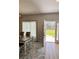 Bright dining room with open doorway, neutral walls, and stylish furniture, creating a welcoming space at 5124 Cr 634S, Bushnell, FL 33513