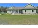 Well-maintained ranch home with a green exterior, stone accents, and a pristine lawn at 5124 Cr 634S, Bushnell, FL 33513