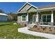 Inviting exterior featuring stone accents, a welcoming front porch, and a well-maintained lawn at 5124 Cr 634S, Bushnell, FL 33513