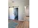 Hallway features modern sliding barn doors with a view to bathroom and stylish rug on the floor at 5124 Cr 634S, Bushnell, FL 33513