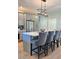 Open kitchen with large quartz island, stainless steel appliances, gray cabinetry and modern pendant lighting at 5124 Cr 634S, Bushnell, FL 33513