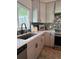 A bright kitchen with quartz countertops, stainless steel appliances, and shaker style gray cabinets at 5124 Cr 634S, Bushnell, FL 33513