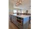 Kitchen island features stylish seating, a wine cooler, a microwave, and ample counter space at 5124 Cr 634S, Bushnell, FL 33513
