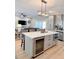 Spacious kitchen island with seating, wine fridge, microwave, and modern lighting at 5124 Cr 634S, Bushnell, FL 33513