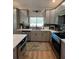 Modern kitchen features gray cabinets, quartz countertops, and stainless steel appliances at 5124 Cr 634S, Bushnell, FL 33513