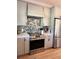 Modern kitchen features stainless steel appliances, gray cabinets, and a decorative backsplash at 5124 Cr 634S, Bushnell, FL 33513