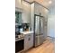 Modern kitchen with stainless steel appliances, ample counter space, and stylish gray cabinetry at 5124 Cr 634S, Bushnell, FL 33513