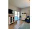 Comfortable living room with sliding glass doors, wood-look floors, and cozy decor at 5124 Cr 634S, Bushnell, FL 33513