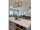 Open-concept living space with kitchen island, dining area, and comfortable seating at 5124 Cr 634S, Bushnell, FL 33513