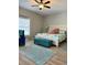 Airy primary bedroom features vaulted ceilings, a king bed with stylish linens, and a cozy sitting area at 5124 Cr 634S, Bushnell, FL 33513