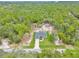 A birds eye view of a home and surrounding property surrounded by lush green space at 5620 Sw 172Nd Loop, Ocala, FL 34473