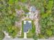 Aerial view of the property with a well-maintained house, a shed and an abundance of surrounding trees at 5620 Sw 172Nd Loop, Ocala, FL 34473