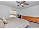 Bright bedroom with a ceiling fan and dresser for storage at 5620 Sw 172Nd Loop, Ocala, FL 34473