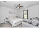 Neutral bedroom features a queen sized bed, a ceiling fan, a window, and grey carpeting at 5620 Sw 172Nd Loop, Ocala, FL 34473